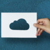 hand hold cloud paper carving with blue background