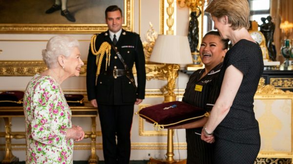 Queen bestows UK health service with top honor and praises