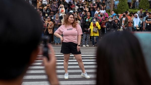 Indonesian teenagers step onto the catwalk at a zebra crossing