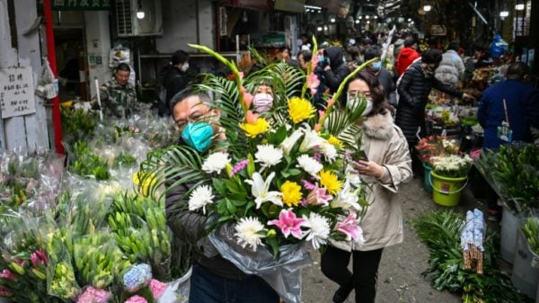 Bustling Wuhan markets celebrate New Year but grief remains